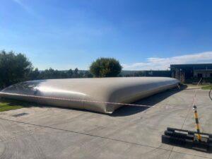 Large flexible PVC water bladder installed at a mining site for industrial water storage and operational water supply.